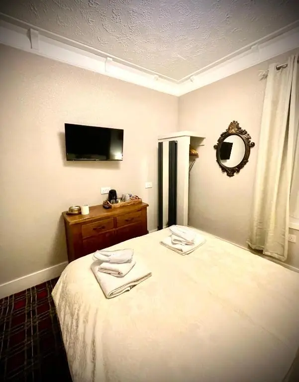 a bedroom with a bed with two towels on it at Stag and Barrel in Elgin