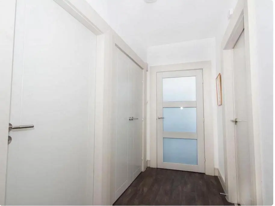 an empty hallway with a door and a window at Mercury Holiday Home 1 Bedroom 7 Westercraigs Apartment -Free Parking in Inverness