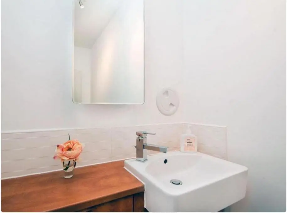 a white bathroom with a sink and a mirror at Mercury Holiday Home 1 Bedroom 7 Westercraigs Apartment -Free Parking in Inverness