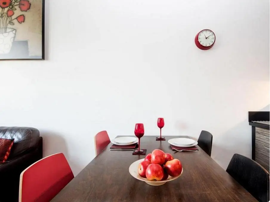 a table with a bowl of apples and two glasses of wine at Mercury Holiday Home 1 Bedroom 7 Westercraigs Apartment -Free Parking in Inverness