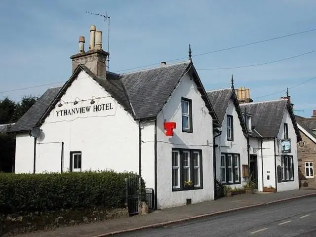 a white building with a sign for a tenneway hotel at Ythanview Hotel
