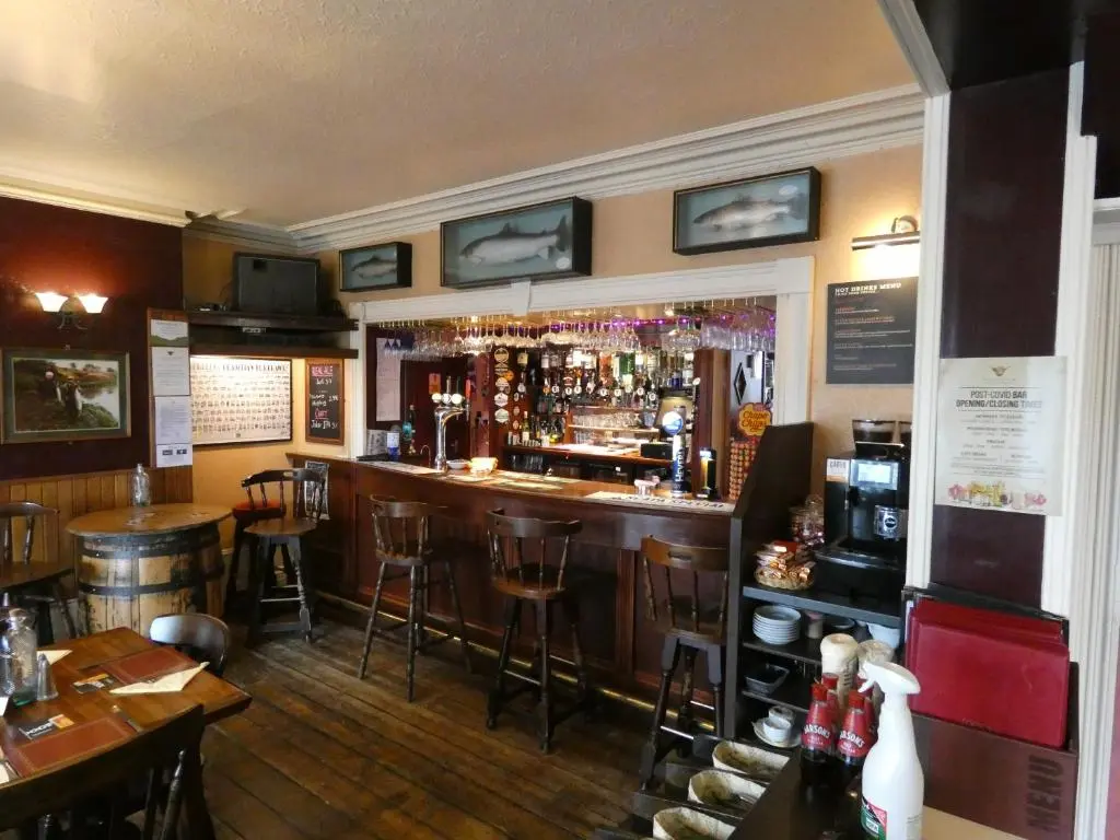 a bar in a restaurant with tables and chairs at Ythanview Hotel