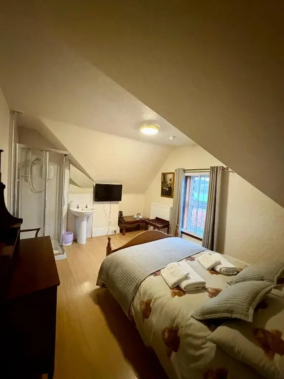 a bedroom with a large bed in an attic at Ythanview Hotel