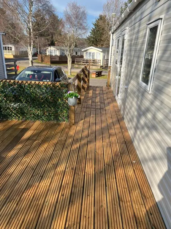 a deck on the side of a house at The Highland Getaway 43 in Boat of Garten