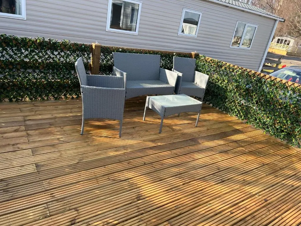 a patio with two chairs and a table at The Highland Getaway 43 in Boat of Garten