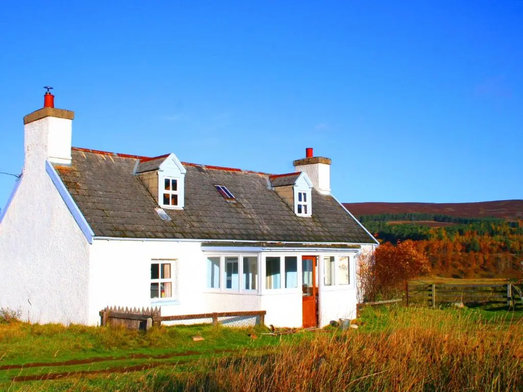 a white house sitting on top of a hill at Strathnoon in Inverness
