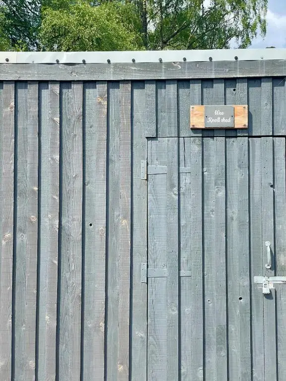 a wooden fence with a sign on top of it at The Wee Knoll in Invergarry