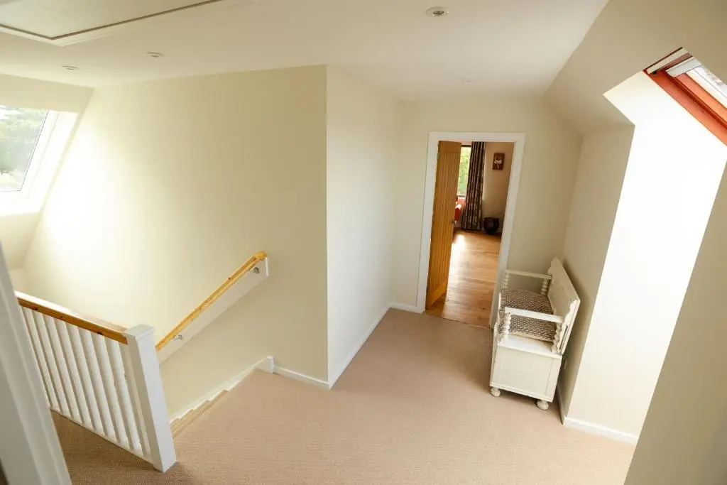 an empty room with a staircase in a house at Caledonian View House in Dalneigh