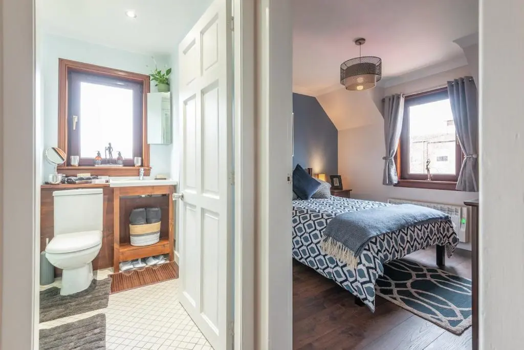 a bedroom with a bed and a sink and a toilet at An I\u00f9bhrach in Inverness