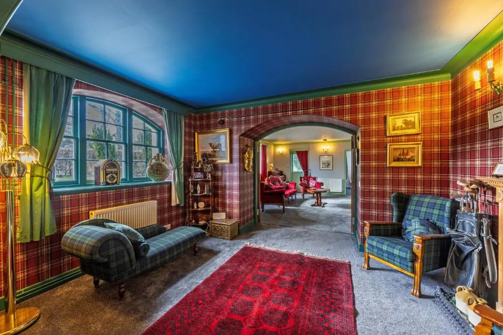 a living room with red tiled walls at Finest Retreats - White House Retreat in Cornhill