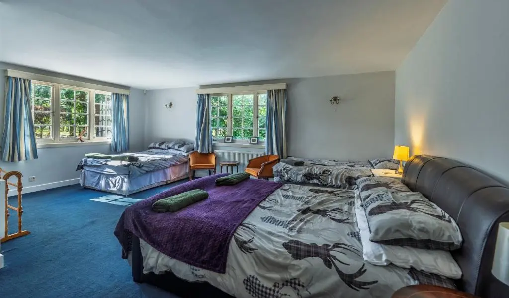 a bedroom with a large bed with a comforter at Finest Retreats - White House Retreat in Cornhill