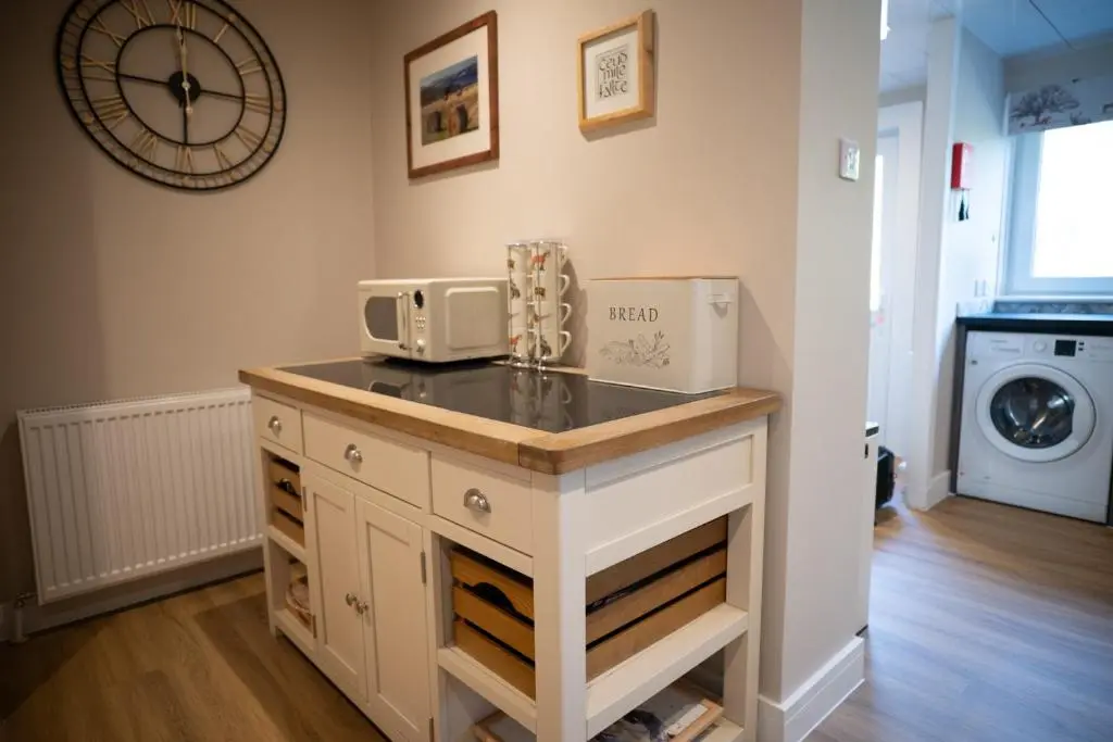 a kitchen with a counter with a microwave on it at Royal Apartment in Inverness