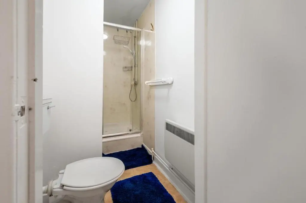 a bathroom with a toilet and a shower at 2 Bed Chalet - Sleeps 3 - River and mountain views in Strathpeffer