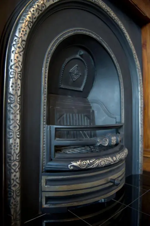 an old fireplace with a black and gold at Springfield guest house in Tain