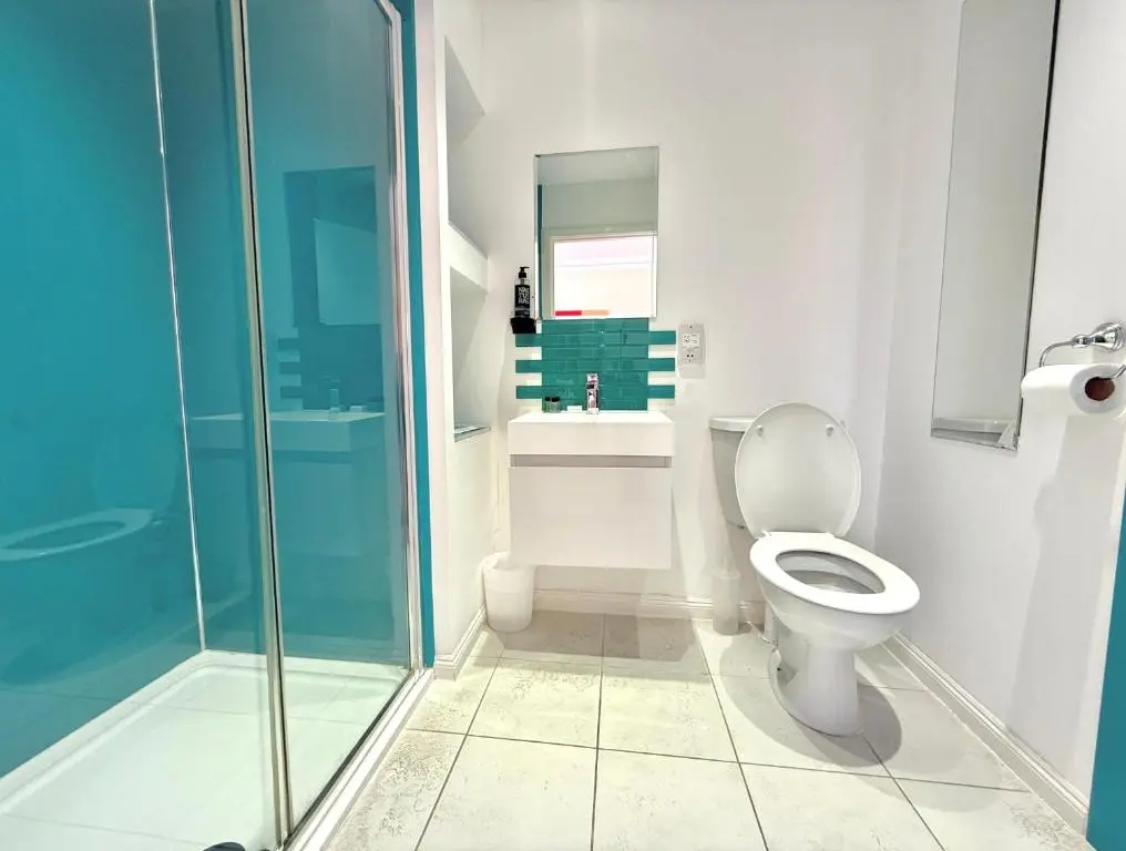 a bathroom with a toilet and a sink and a shower at Seabank House Hotel in Nairn