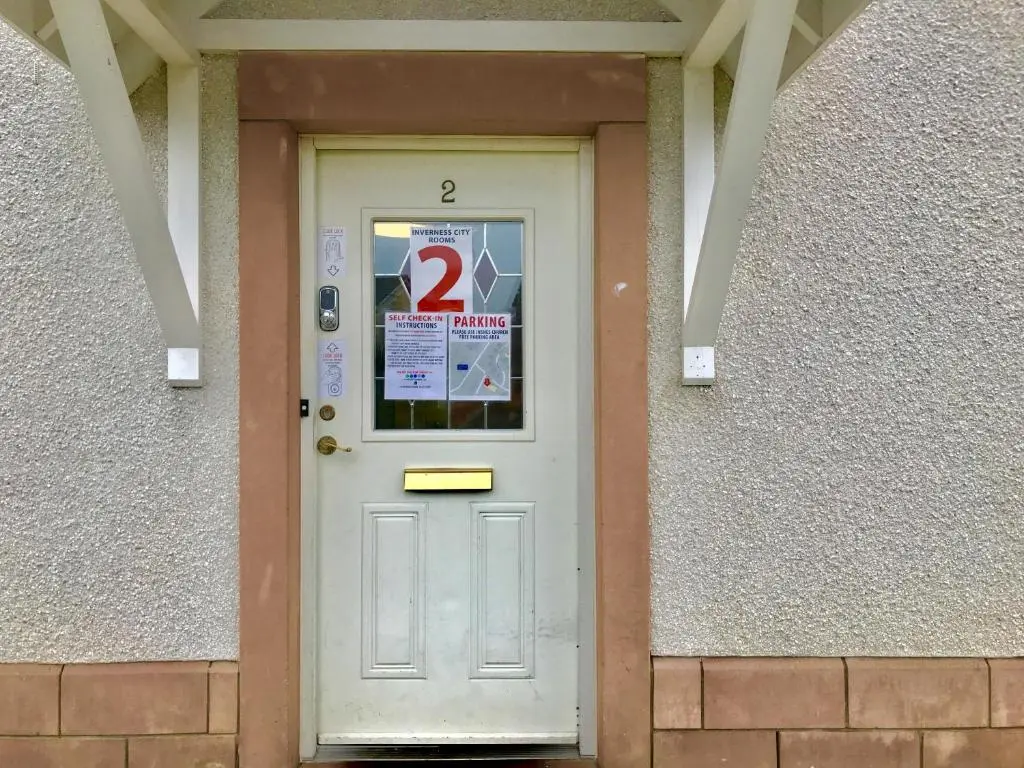 a white door with a number two on it at Woodgrove Holiday Homes in Inshes