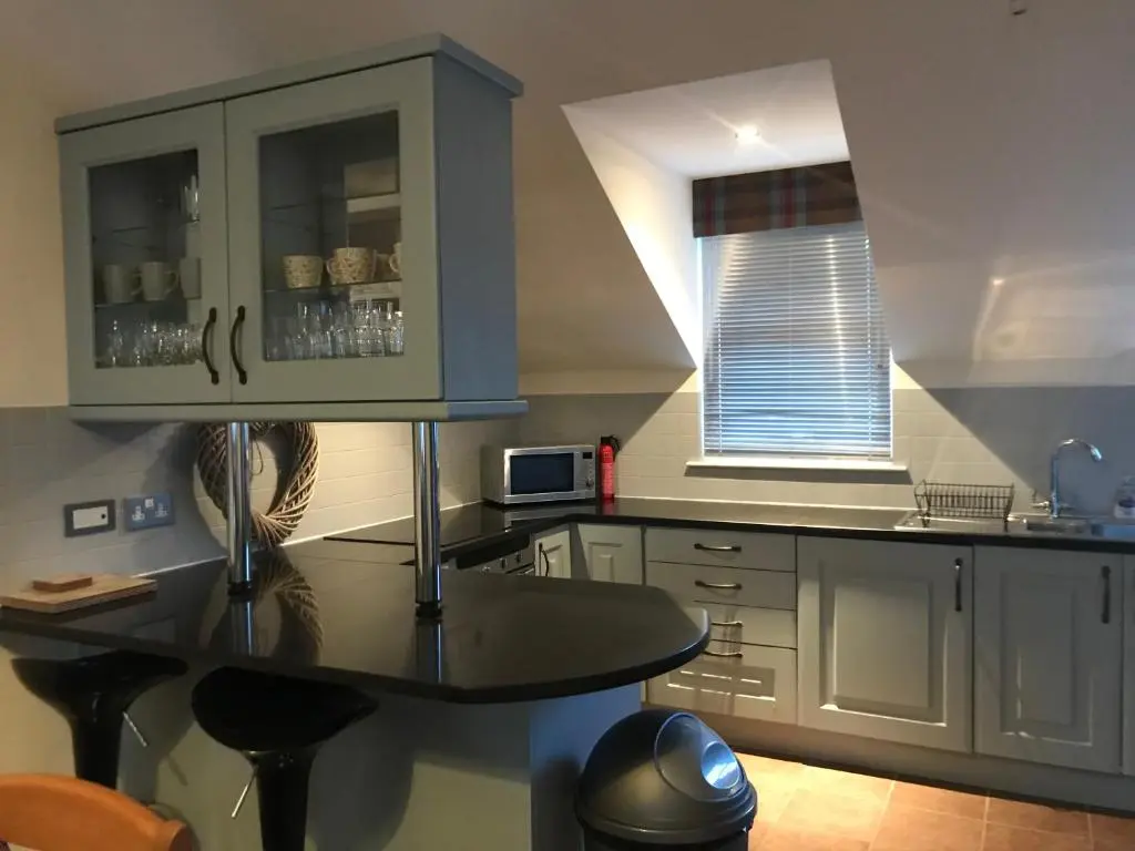 a kitchen with a table and a counter top at The Town House in Dornoch