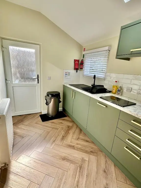 a kitchen with a sink and a counter top at Luxury Coastal Cottage in Portsoy