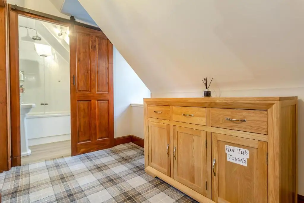 a bathroom with a wooden cabinet with a sign on it at 3 Bed in Huntly oc-g31733 in Huntly