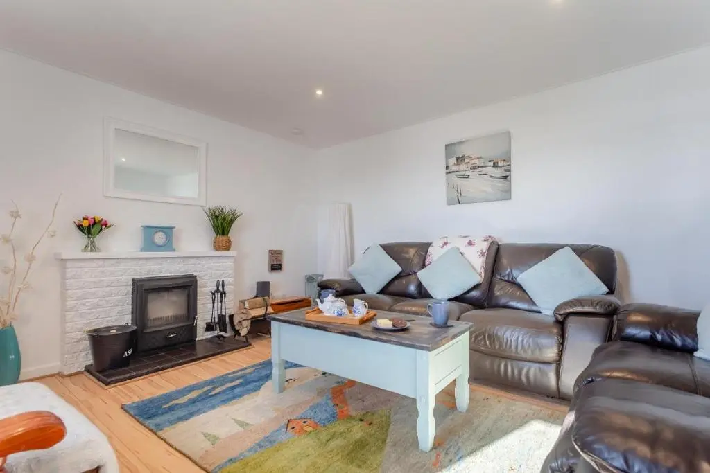 a living room with a couch and a fireplace at 3 Bed in Avoch oc-c31805 in Avoch