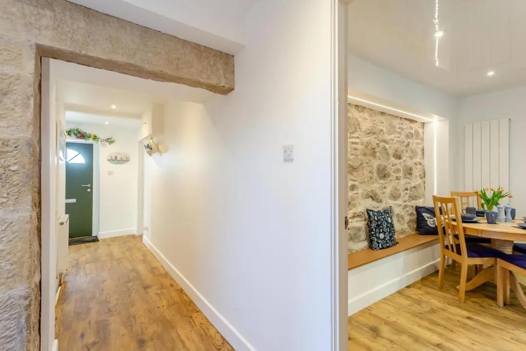 a kitchen and dining room with a stone wall at 3 Bed in Avoch oc-c31805 in Avoch