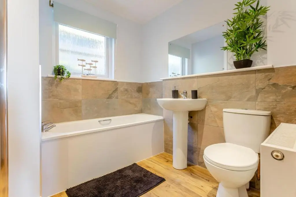 a bathroom with a toilet and a sink and a bath tub at 3 Bed in Avoch oc-c31805 in Avoch