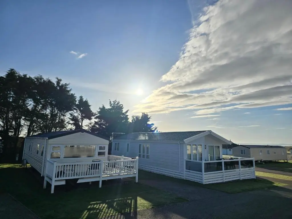 two white modular homes with a cloudy sky at 3 Bed-Sleeps 8-Free Parking-5 Min to Beach in Dornoch