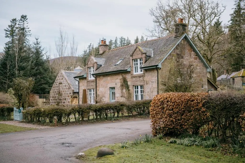 an old stone house with a road in front of it at Gamekeeper's Cottage in Banchory