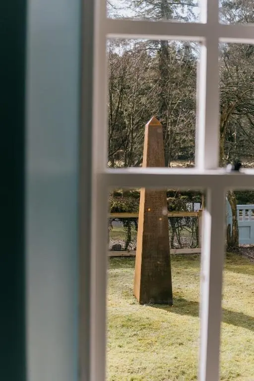 a view of a statue through a window at Gamekeeper's Cottage in Banchory