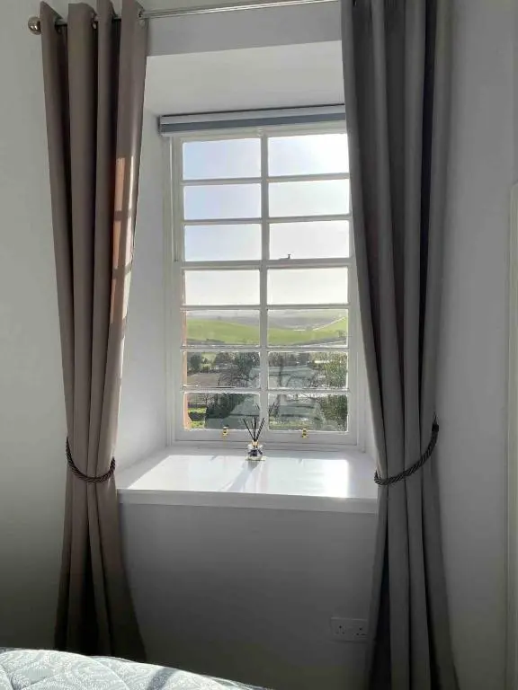 a window with a bath tub in a bedroom at 2 bedroom Townhouse within Grade C listed Ladysbridge House 2 night minimum stay in Ladysbridge Station