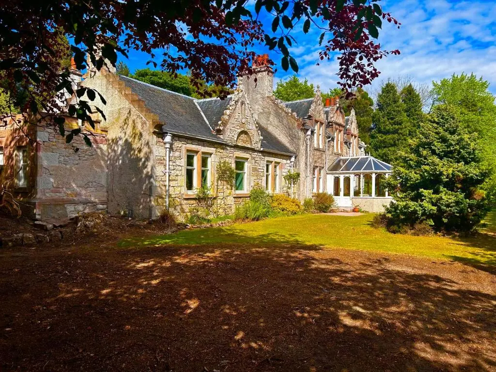 an old stone house with a large yard at Clashmore House Garden Cottage Dornoch in Dornoch