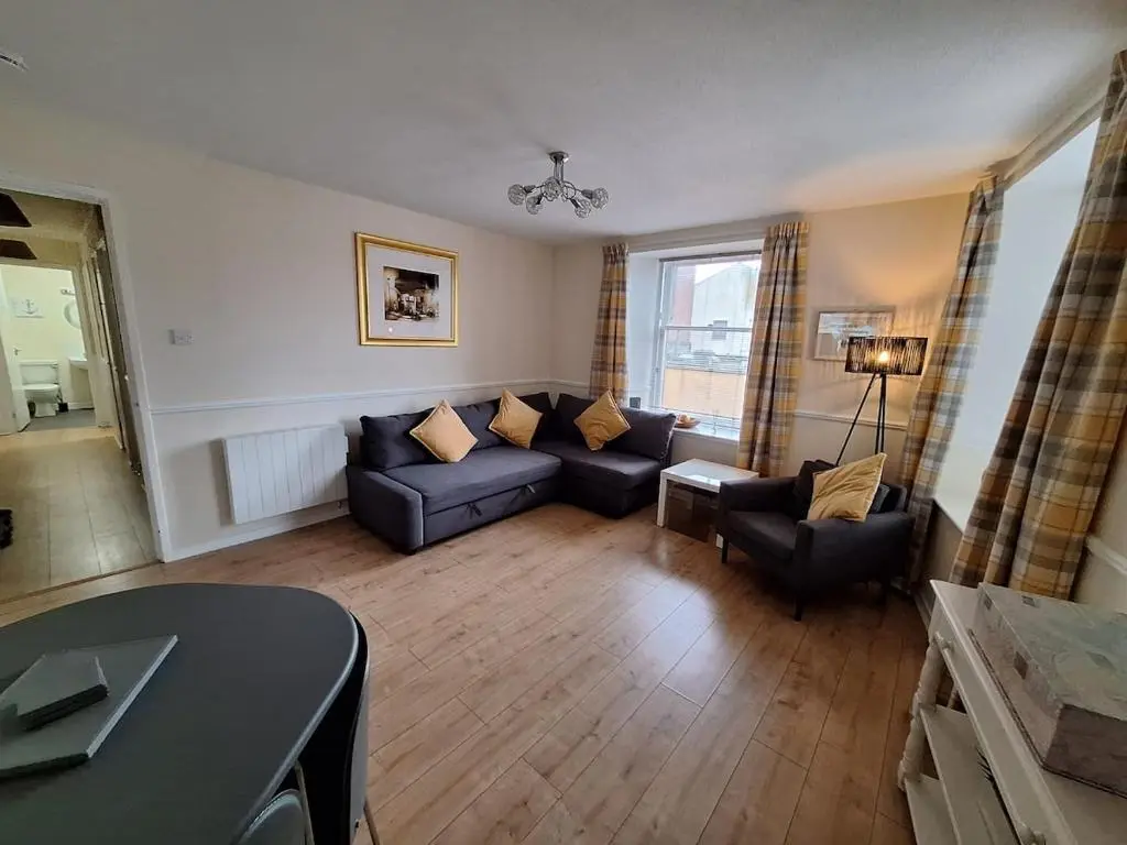 a living room with a couch and chairs and a table at Inverness City Centre Apartment! in Inverness