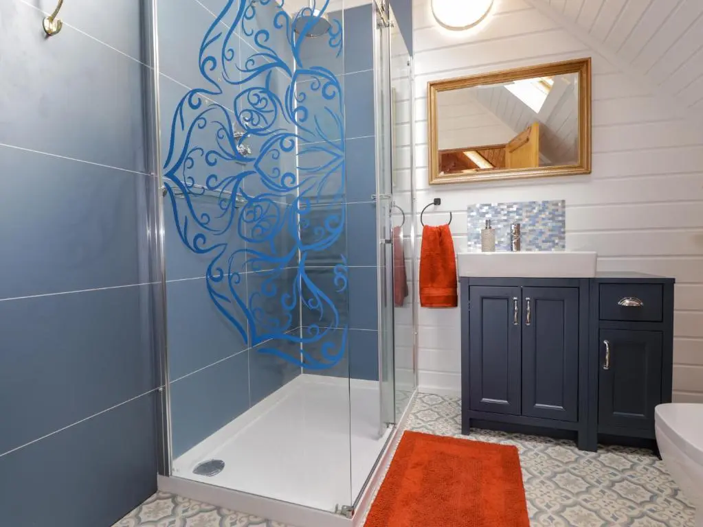 a bathroom with a shower with a glass door at The Lodge in Beauly