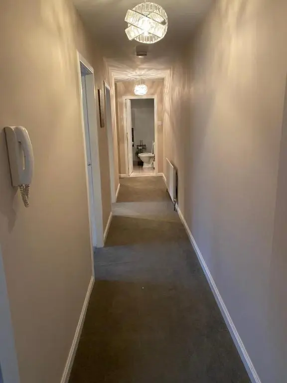 a hallway with a long hallwayngth at Impala Apartment in Wick