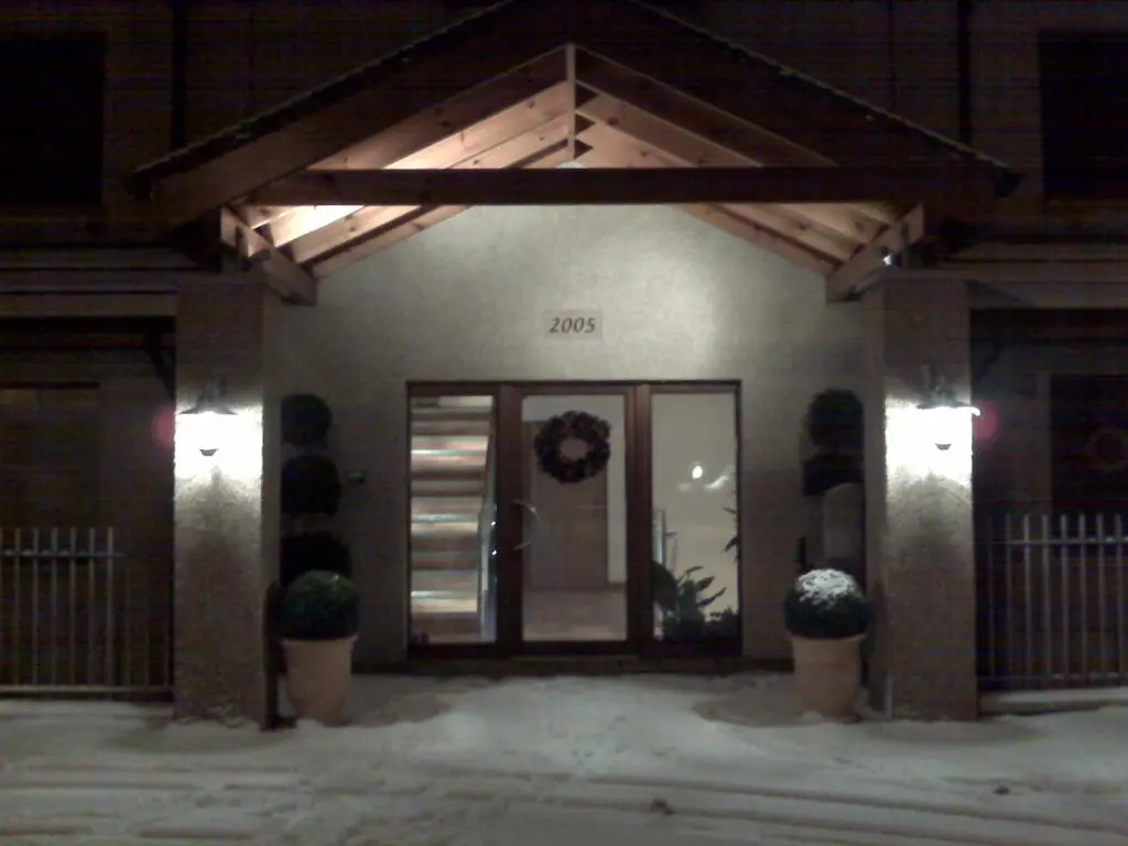 a front door of a house with two potted plants at Penthouse Golf View Apartments in Lossiemouth