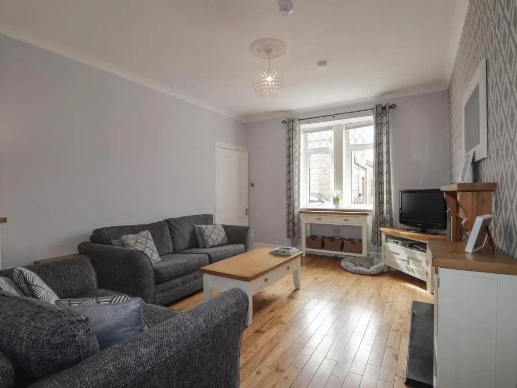 a living room with a couch and a tv at 6 New Street in Elgin