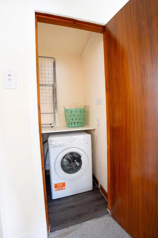 a washer and dryer in a small room at Lovely & Bright 2 Bed Apartment in Inverness