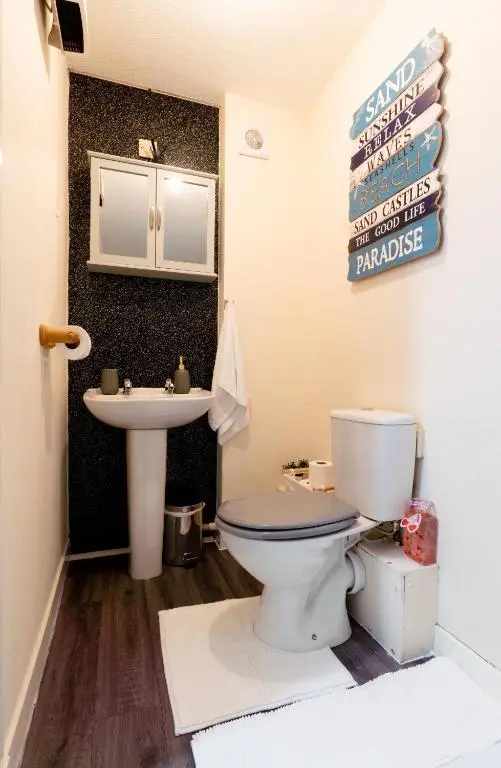 a bathroom with a toilet and a sink at Lovely & Bright 2 Bed Apartment in Inverness