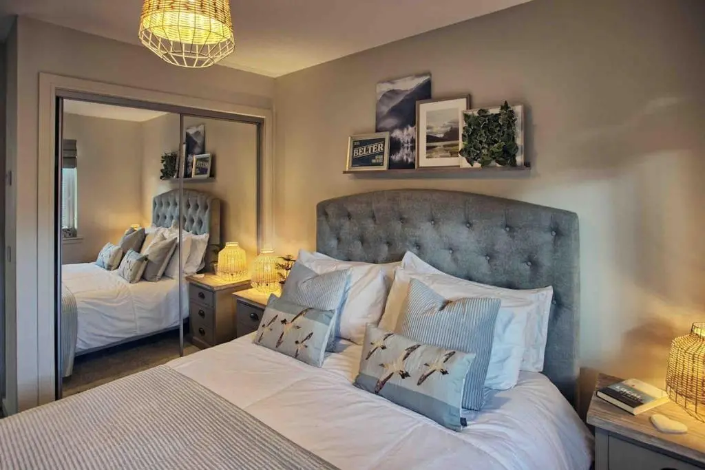 a bedroom with two beds and a large mirror at Luxury Apartment Alford Aberdeenshire in Alford