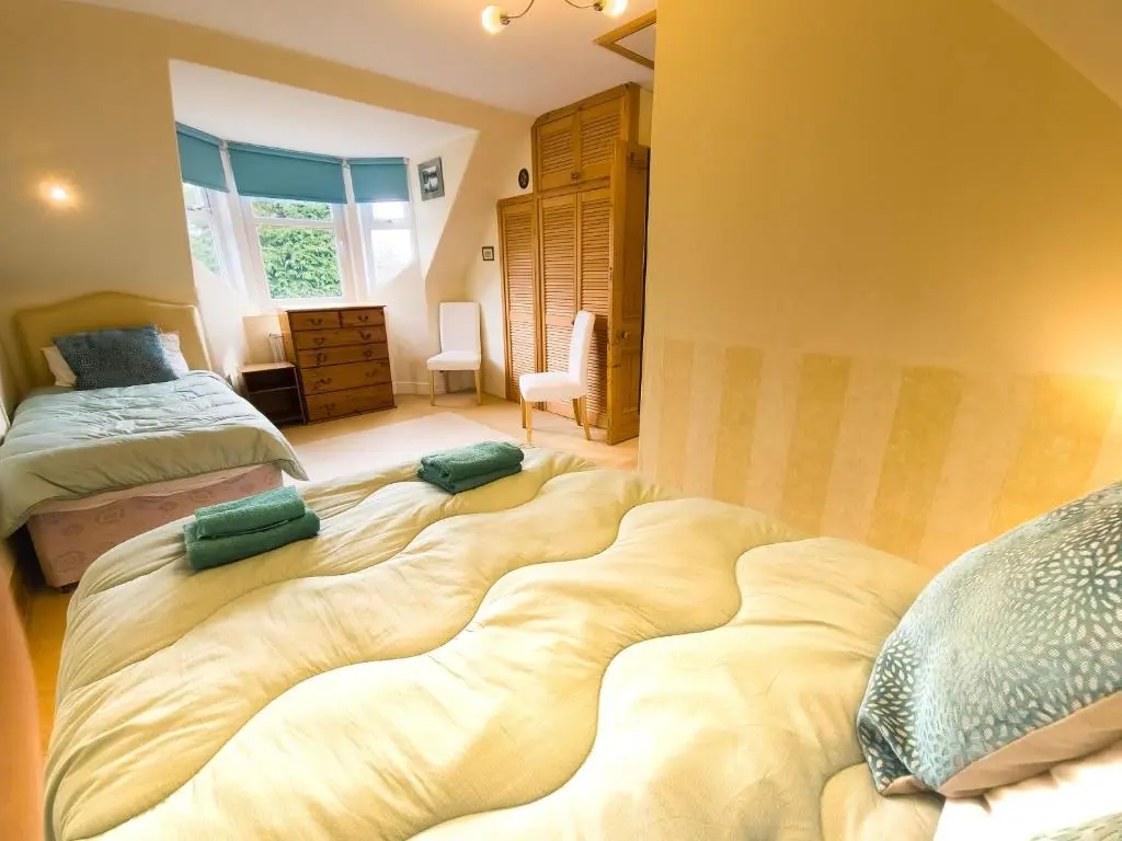 a large bed in a room with two beds at Birchview in Aviemore