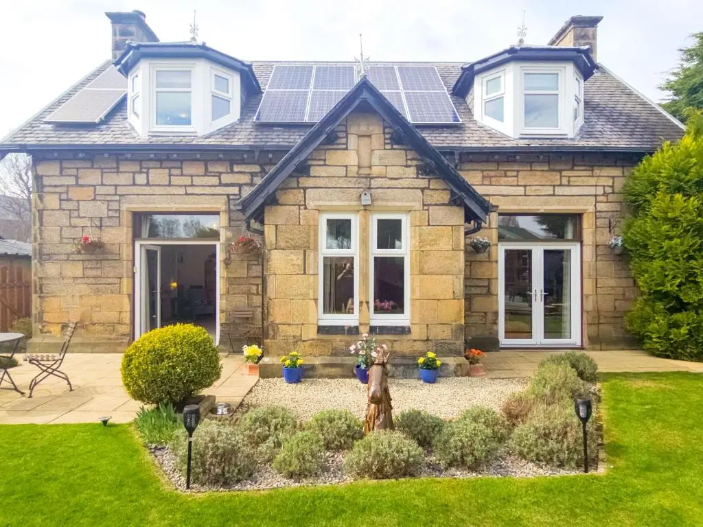 a house with solar panels on the roof at Birchview in Aviemore
