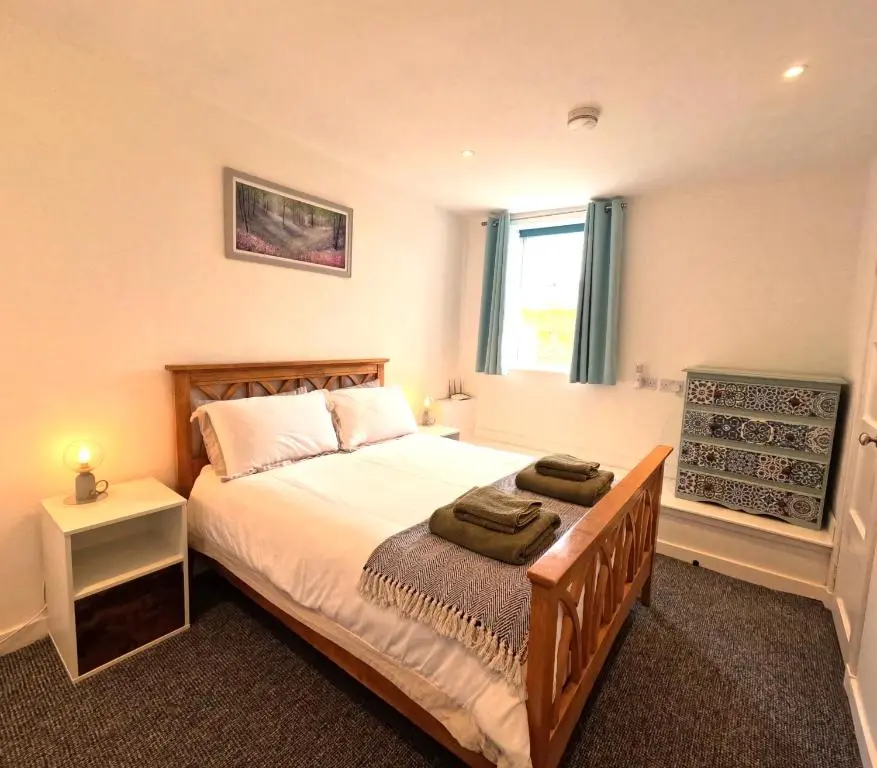 a bedroom with a bed with two towels on it at Rockview Barn in Dufftown