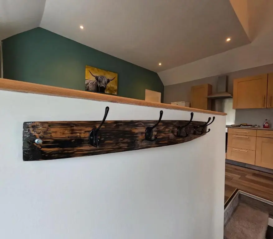 a log shelf on a wall in a kitchen at Rockview Barn in Dufftown