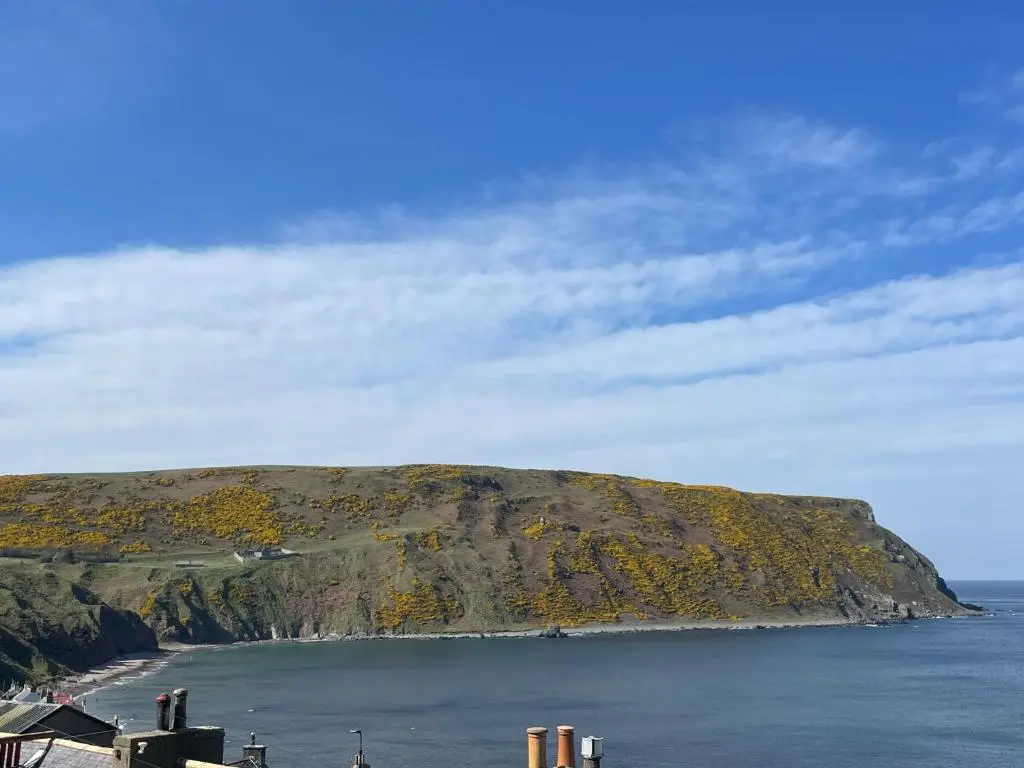 an island in the ocean next to the water at Gamrie Beach Bothy in Gardenstown