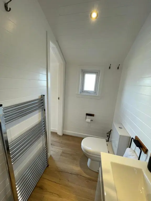 a bathroom with a toilet and a sink and a window at Gamrie Beach Bothy in Gardenstown
