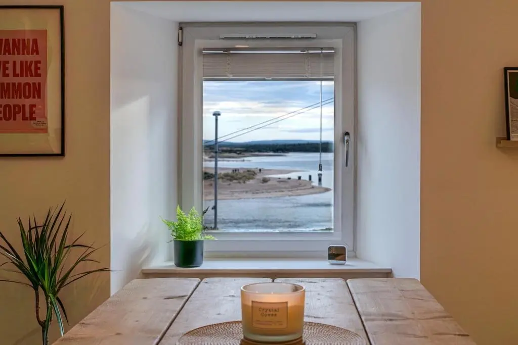 a table in a room with a window at The Lookout, Lossiemouth in Lossiemouth