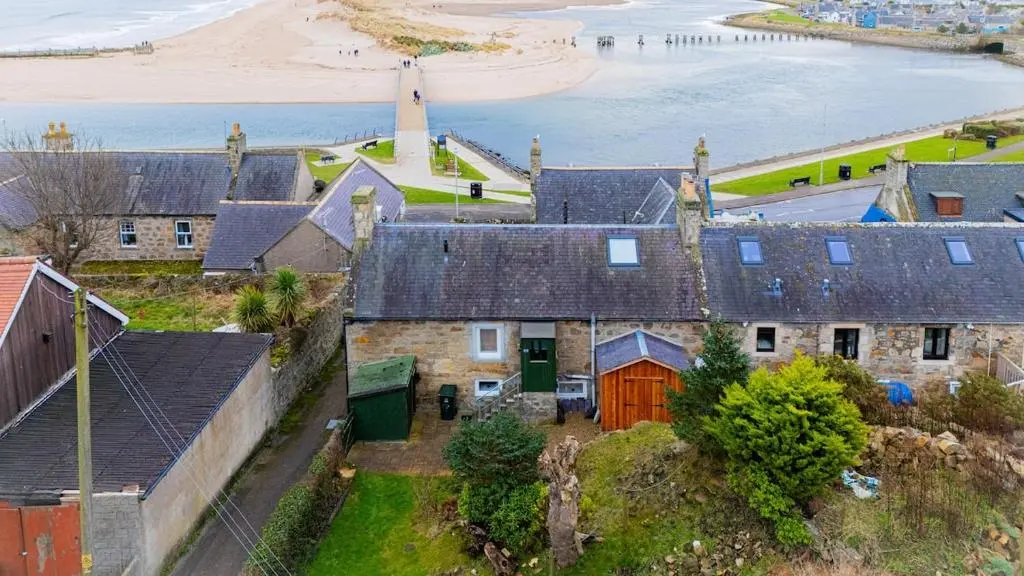 an aerial view of a group of houses and the beach at The Lookout, Lossiemouth in Lossiemouth