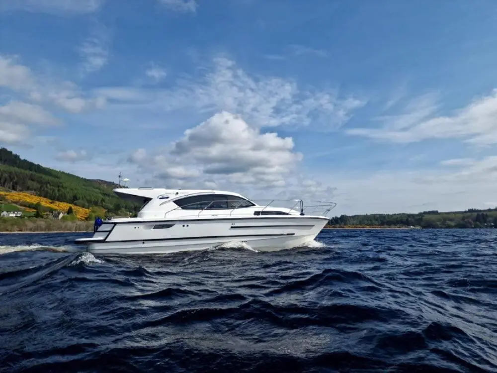 a white boat on a large body of water at Islay Class 2 in Inverness