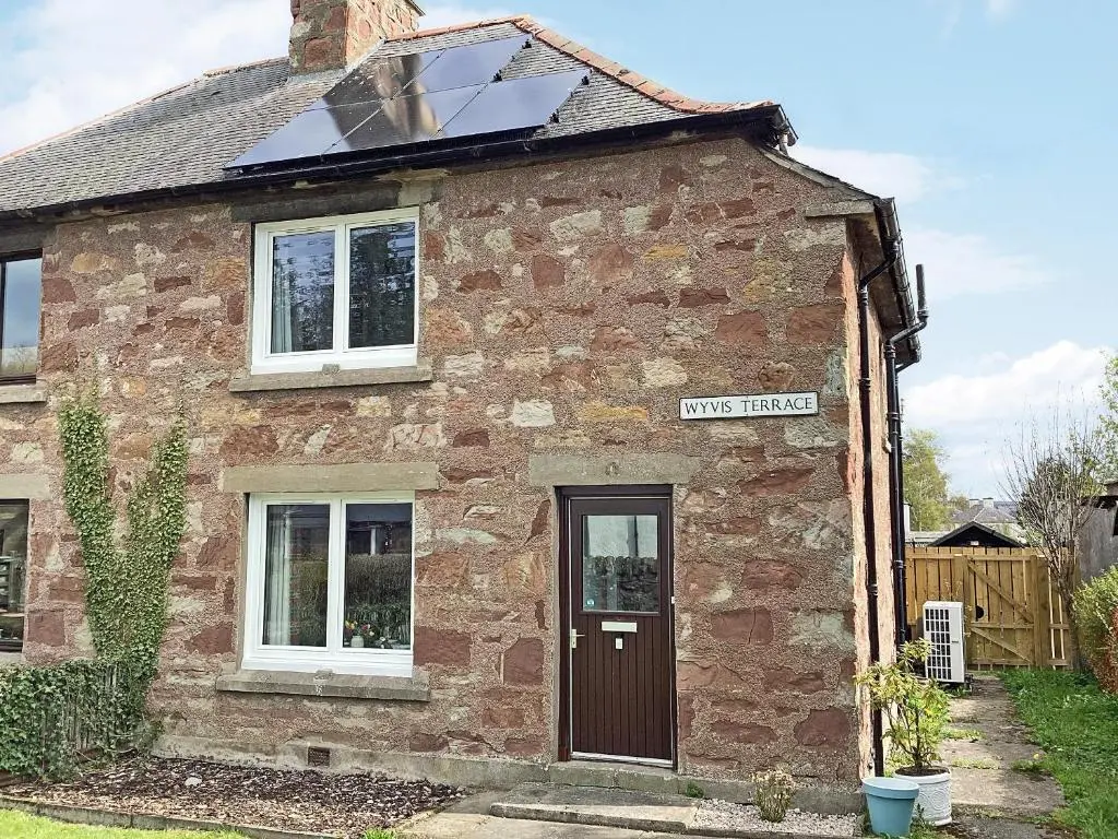 an old brick house with a solar roof at Seasgair in Dingwall