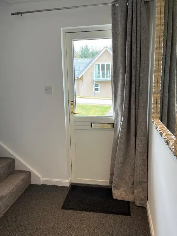 a door with a window in a room at Inchmarlo Villa 29 Banchory in Inchmarlo